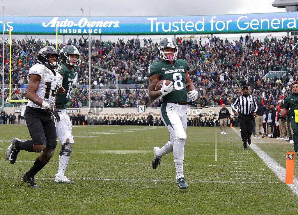 Al Goldis Michigan State's Jalen Nailor (8) scores a touchdown against Purdue's Antonio Blackmon (14) as Michigan State quarterback Rocky Lombardi, left rear, trails during the fourth quarter of an NCAA college football game, Saturday, Oct. 27, 2018, in East Lansing, Mich. (AP Photo/Al Goldis)