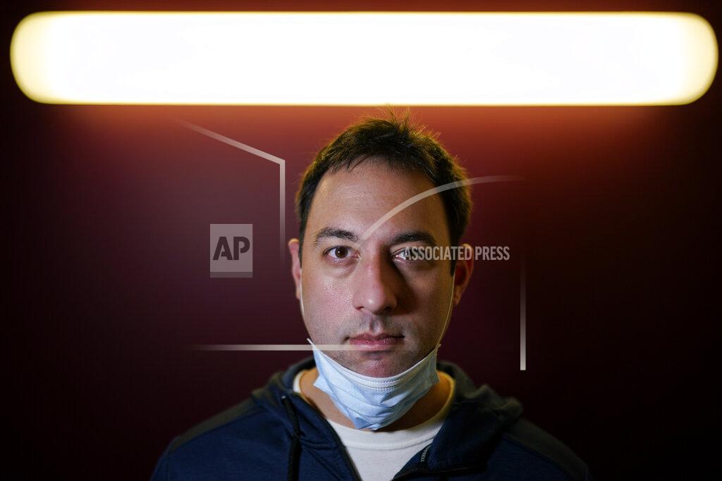 Chris Carlson Evan Metaxatos poses for a pictures on Monday, Nov. 30, 2020, in Charlotte, N.C. An analysis shows that few Americans are utilizing contact tracing technology launched in a host of U.S. states and territories. (AP Photo/Chris Carlson)