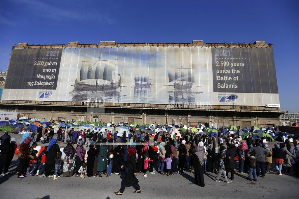 Thanassis Stavrakis FILE - In this Wednesday, March 30, 2016 file photo, refugees and migrants wait in queues to receive food distributed by non-governmental organisation at the Athens' port of Piraeus. Five years on, the deal between European Union and Turkey is no longer working but at a summit next week EU leaders will discuss ways to improve relations with Turkey and could try to revive the agreement. (AP Photo/Thanassis Stavrakis, File)