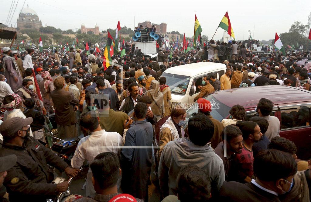 Asim Tanveer Supporters of the Pakistan Democratic Movement, an alliance of opposition parties, attend an anti-government rally, in Multan, Pakistan, Monday, Nov. 30, 2020. Despite a government ban and arrests of hundreds of activists, Pakistani opposition supporters rallied in a central city on Monday, calling on Prime Minister Imran Khan to resign over alleged bad governance and incompetence. (AP Photo/Asim Tanveer)
