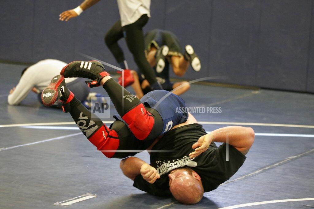 Nati Harnik In this March 2, 2020, photo, former Nebraska football player Tanner Farmer and current wrestler for Concordia University is seen during practice in Seward, Neb. (AP Photo/Nati Harnik)