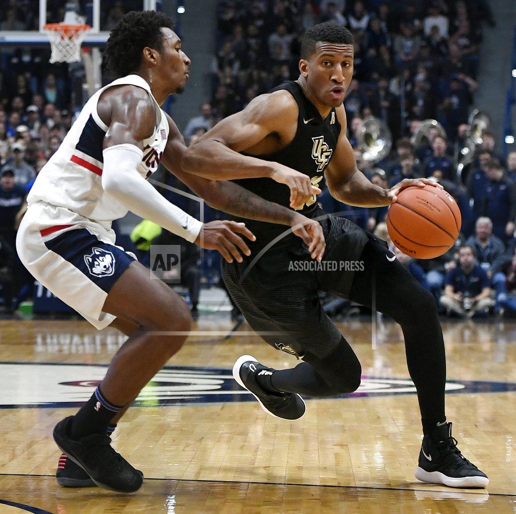 Jessica Hill Central Florida's Aubrey Dawkins dribbles as Connecticut's Christian Vital, left, defends during the first half of an NCAA college basketball game, Saturday, Jan. 5, 2019, in Hartford, Conn. (AP Photo/Jessica Hill)