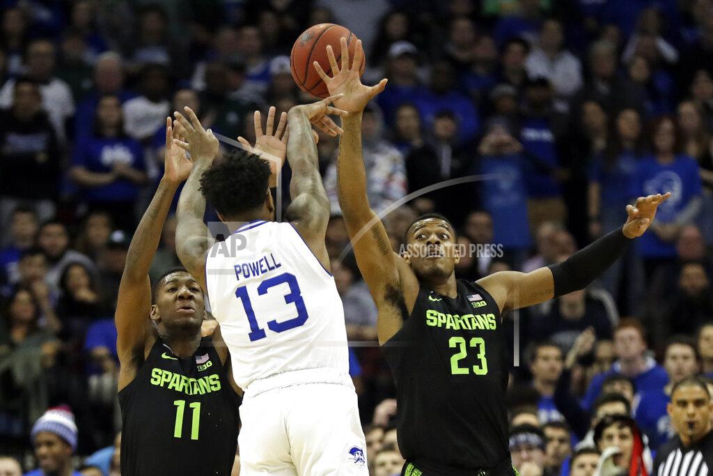 Adam Hunger Seton Hall guard Myles Powell (13) passes over Michigan State forward Xavier Tillman (23) and Michigan State forward Aaron Henry (11) during the first half of an NCAA college basketball game Thursday, Nov. 14, 2019, in Newark, N.J. (AP Photo/Adam Hunger)