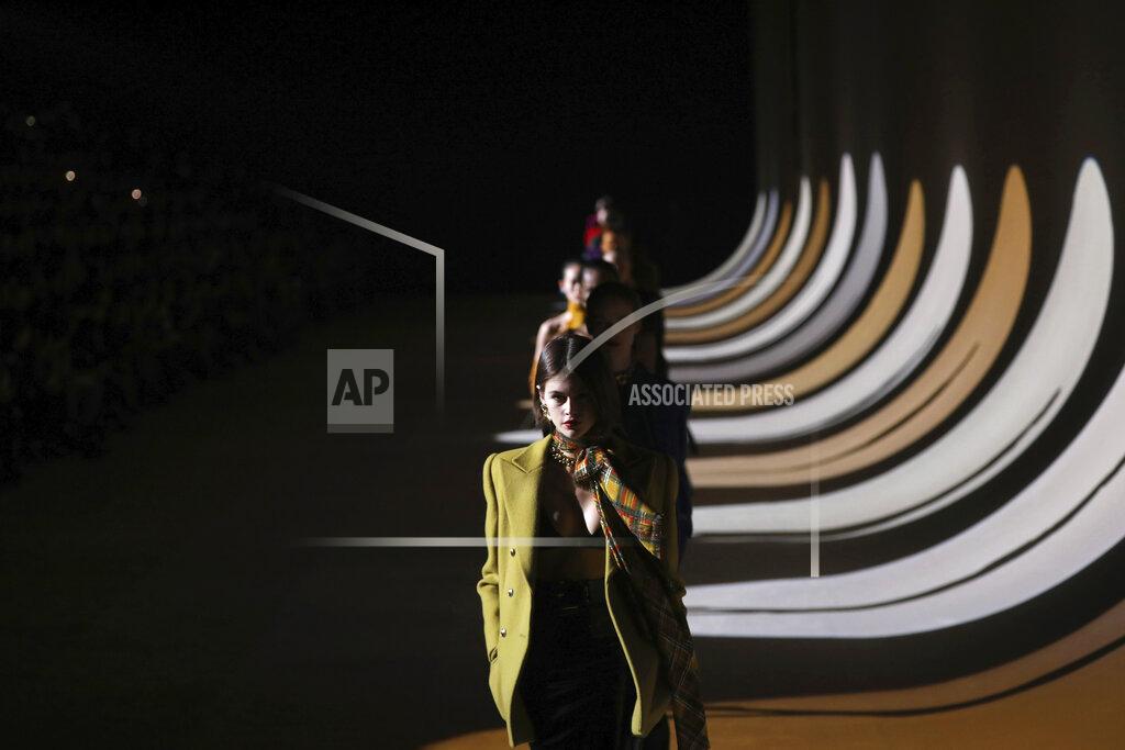 Vianney Le Caer FILE - In this Feb. 25, 2020 file photo, model Kaia Gerber leads other models as they wear creations for the Saint Laurent fashion collection during Women's fashion week Fall/Winter 2020/21 presented in Paris. The coronavirus pandemic has instilled extra unpredictability into the already fickle Paris Fashion Week. After first canceling the July shows for menswear and Haute Couture, the French fashion federation has now organized an unprecedented schedule of digital-only events instead. (Photo by Vianney Le Caer/Invision/AP, File)