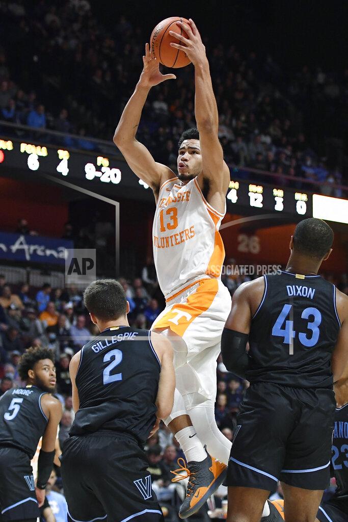 Jessica Hill Tennessee's Olivier Nkamhoua (13) is called for charging as Villanova's Collin Gillespie (2) defends in the first half of an NCAA college basketball game, Saturday, Nov. 20, 2021, in Uncasville, Conn. (AP Photo/Jessica Hill)