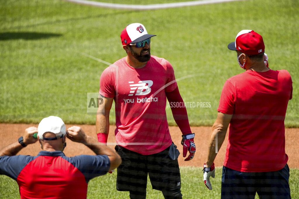 Andrew Harnik Washington Nationals' Adam Eaton (2), center, speaks with a staff member as the team holds its first baseball training camp workout at Nationals Stadium, Friday, July 3, 2020, in Washington. (AP Photo/Andrew Harnik)