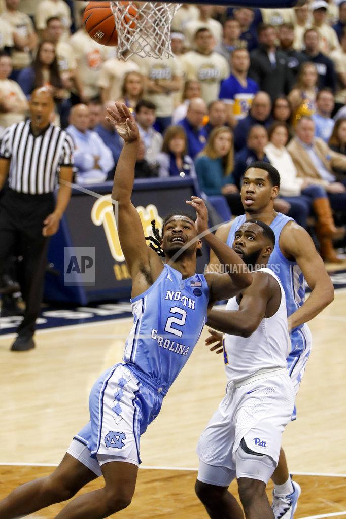 Keith Srakocic North Carolina's Coby White (2) puts up a shot past Pittsburgh's Trey McGowens, right, during the second half of an NCAA college basketball game, Saturday, Jan. 5, 2019, in Pittsburgh. North Carolina won 85-60. (AP Photo/Keith Srakocic)