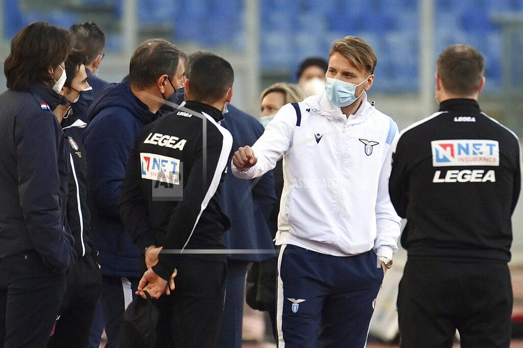 Alfredo Falcone Lazio's Ciro Immobile, 2nd from right, stands on the pitch prior to the Serie a soccer match between Lazio and Torino, at the Rome Olympic Stadium Tuesday, March 2, 2021. Lazio walked out into Stadio Olimpico for its Serie A match on Tuesday even though it knows its Torino opponents are still in Turin. A coronavirus outbreak forced Torino players and staff into self-isolation that doesn't end until midnight Tuesday, hours after the scheduled kickoff against Lazio in Rome. (Alfredo Falcone/LaPresse via AP)