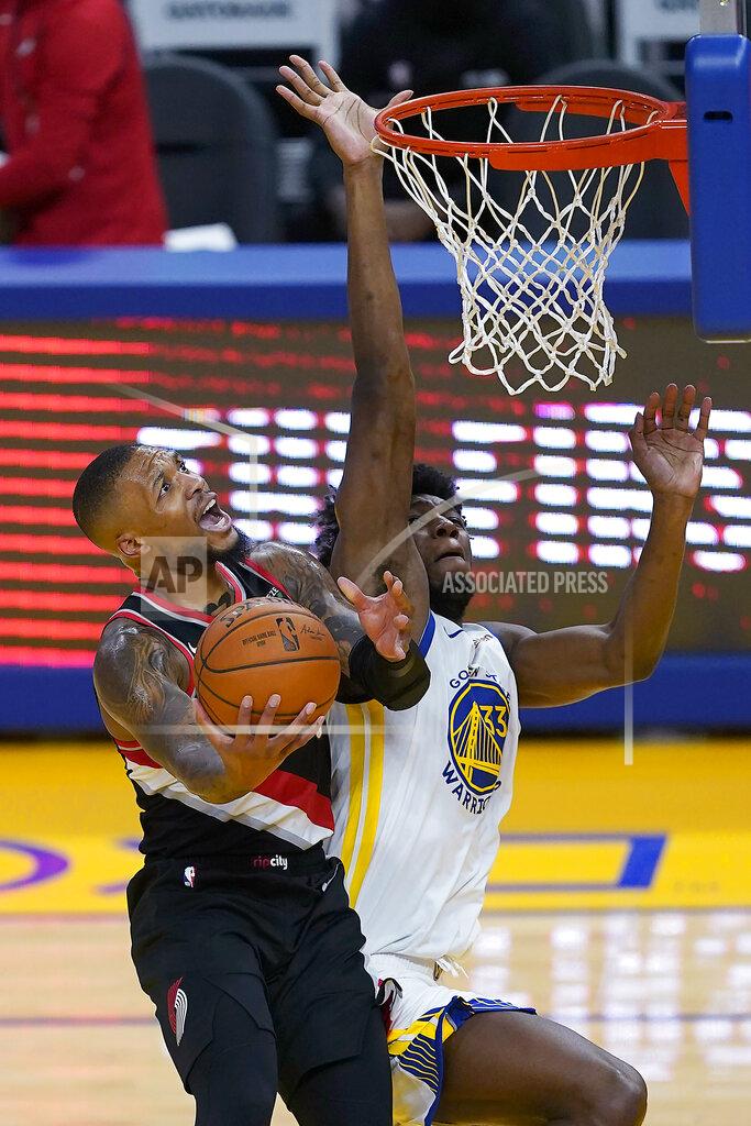 Tony Avelar Portland Trail Blazers guard Damian Lillard (0) drives to the basket against Golden State Warriors center James Wiseman (33) during the first half of an NBA basketball game in San Francisco, Friday, Jan. 1, 2021. (AP Photo/Tony Avelar)