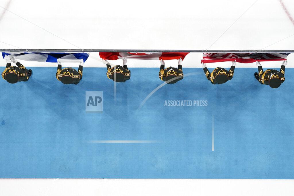 Matt Slocum The flags of Canada, the United States, and Finland are presented during the medal ceremony after Canada defeated the United States in the women's gold medal hockey game at the 2022 Winter Olympics, Thursday, Feb. 17, 2022, in Beijing. (AP Photo/Matt Slocum)