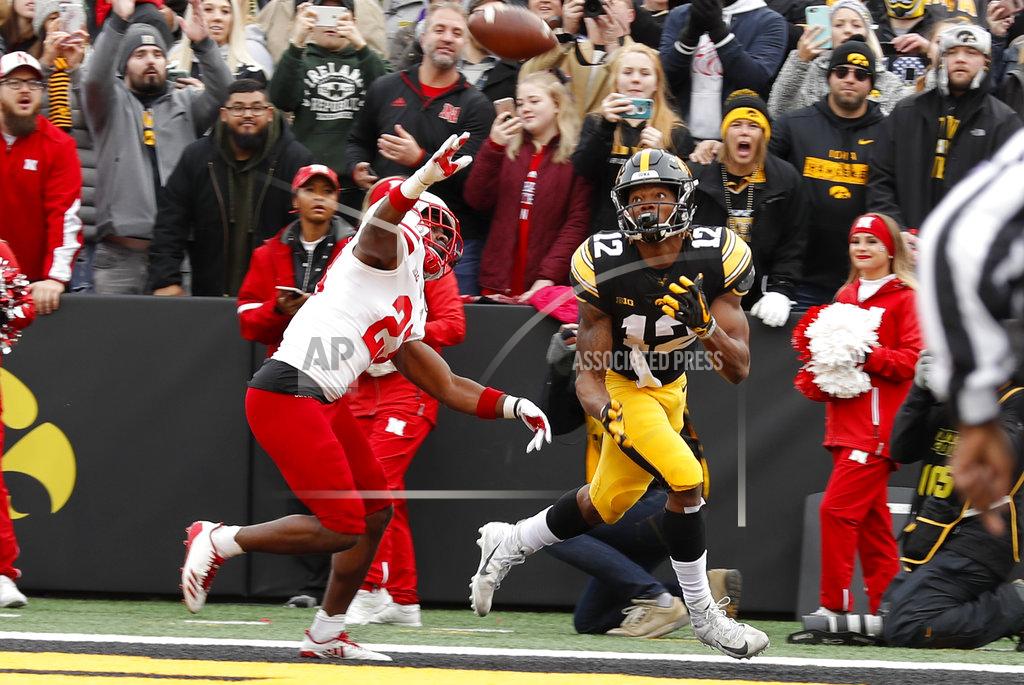 Charlie Neibergall Iowa wide receiver Brandon Smith (12) catches a 15-yard touchdown pass in front of Nebraska defensive back Dicaprio Bootle, left, during the first half of an NCAA college football game, Friday, Nov. 23, 2018, in Iowa City, Iowa. (AP Photo/Charlie Neibergall)