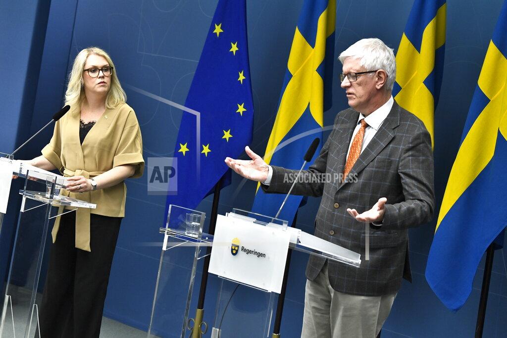 Lena Hallengren Minister for Health and Social Affairs, left, and Johan Carlson, Director General for the Swedish Public Health Agency, hold a news conference on Tuesday, May 26, 2020, about restrictions for vulnerable citizens over 70-years old in Stockholm, Sweden, Tuesday May 26, 2020. (Claudio Bresciani / TT via AP)