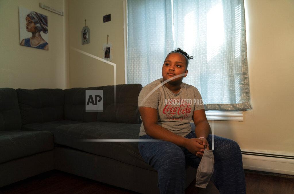 David Goldman Darelyn Maldonado, 12, poses for a portrait at her home in Pawtucket, R.I., Wednesday, March 3, 2021. Maldonado, a seventh grade student, has been out of in person school for a year since the pandemic began. Her mother, who also has a one-year-old son, got a job recently working at a liquor store but had to leave it because she said it was all too much. She also didn't feel safe being around so many customers. Maldonado feels like she's lost friends over the past year and just wants her life to go back to normal. (AP Photo/David Goldman)