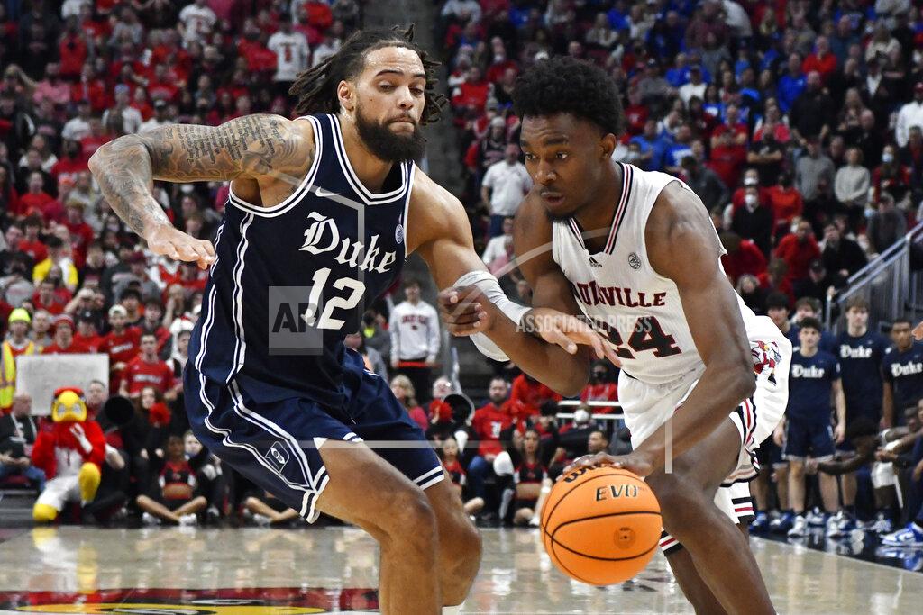 Timothy D. Easley Louisville forward Jae'Lyn Withers (24) drives to the basket against Duke forward Theo John (12) during the second half of an NCAA college basketball game in Louisville, Ky., Saturday, Jan. 29, 2022. Duke won 74-65. (AP Photo/Timothy D. Easley)