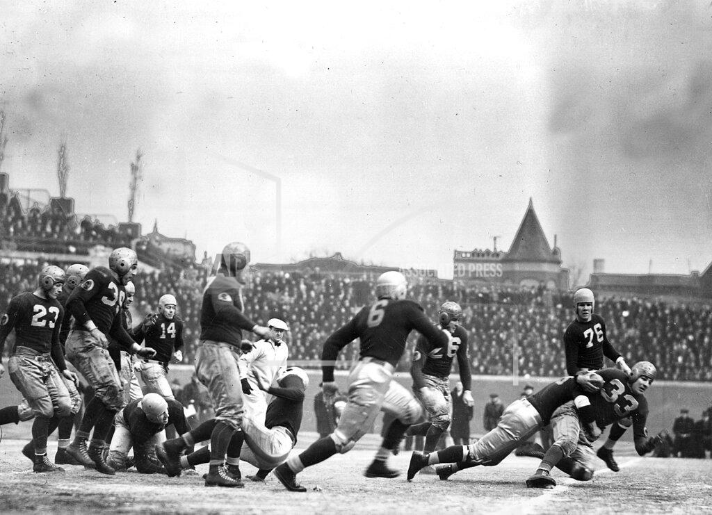 Uncredited FILE - In this Dec. 12, 1937, file photo, Washington Redskins quarterback Sammy Baugh (33) is brought down after a gain, by the Chicago Bears during an NFL football Championship game on a frozen Wrigley Field in Chicago. The Redskins won 28-21. (AP Photo/File)