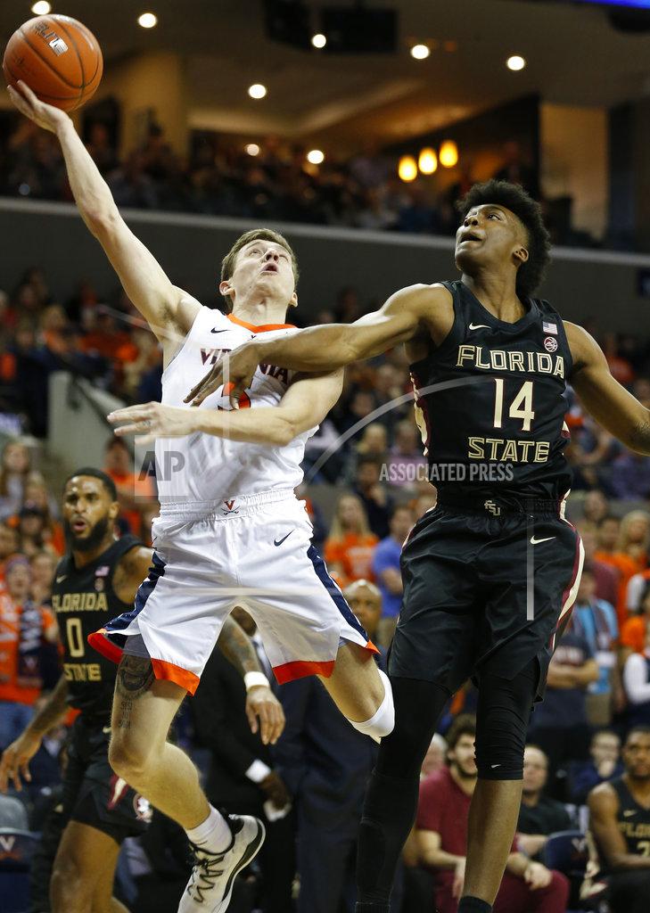 Steve Helber Virginia guard Kyle Guy (5) is fouled as he goes up for a shot against Florida State guard Terance Mann (14) during the first half of an NCAA college basketball game in Charlottesville, Va., Saturday, Jan. 5, 2019. (AP Photo/Steve Helber)