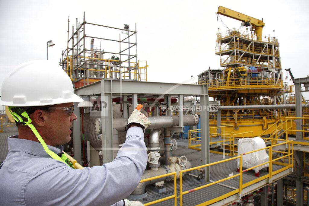 Jophn L. Mone In this Tuesday March 10, 2020 photo, David Nickerson, CEO of Marine Well Containment Company, points to the hydrocarbon train that fits on top a oil spill disaster response tanker, in Ingleside, Texas. The device helps process spilled oil and other hydrocarbons. It also helps collect oil spewing out of blown out deep sea wells for storage in oil tankers hulls.(AP Photo/John L. Mone)