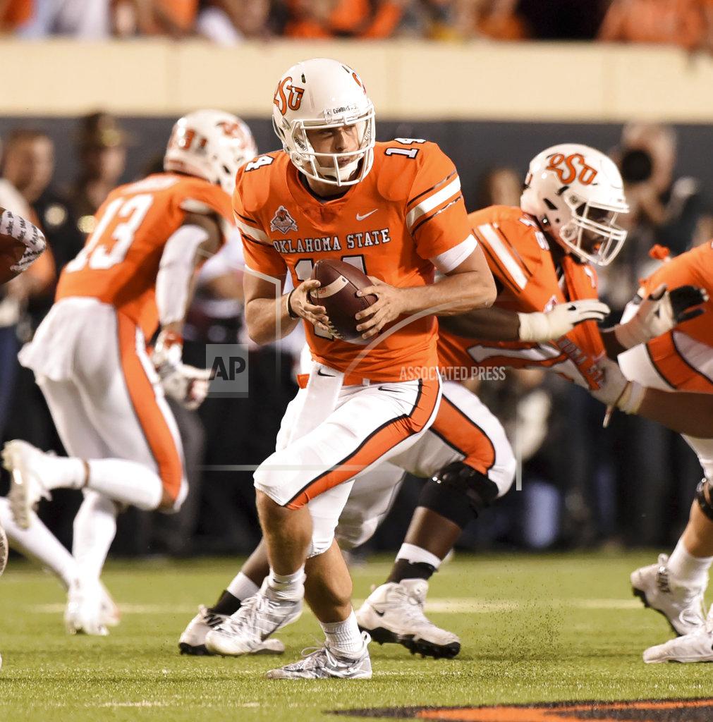 Brody Schmidt Oklahoma State quarterback Taylor Cornelius looks for an open teammate in the second half of an NCAA college football game in Stillwater, Okla., Saturday, Oct. 27, 2018. Cornelius threw for 321 yards in the Oklahoma State 38-35 win over Texas.(AP Photo/Brody Schmidt)