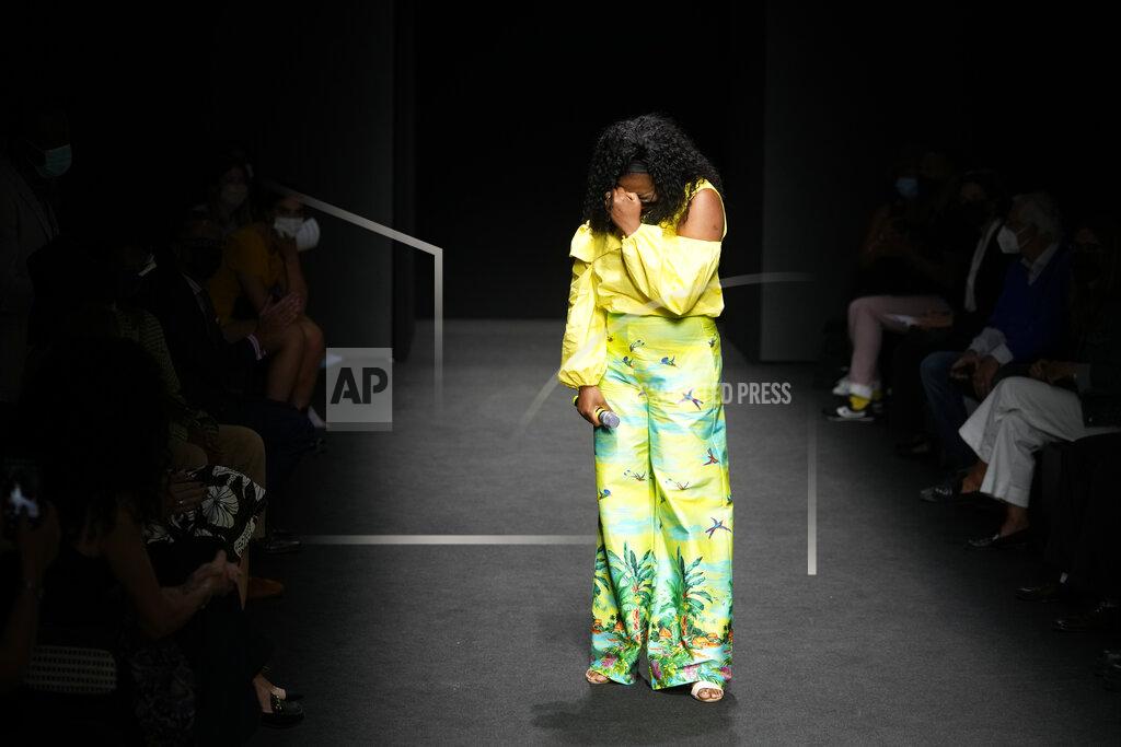 Luca Bruno Designer Joy Meribe is overcome by emotion at the end of her Spring Summer 2022 collection, unveiled during the Milan Fashion Week, in Milan, Italy, Wednesday, Sept. 22, 2021. (AP Photo/Luca Bruno)