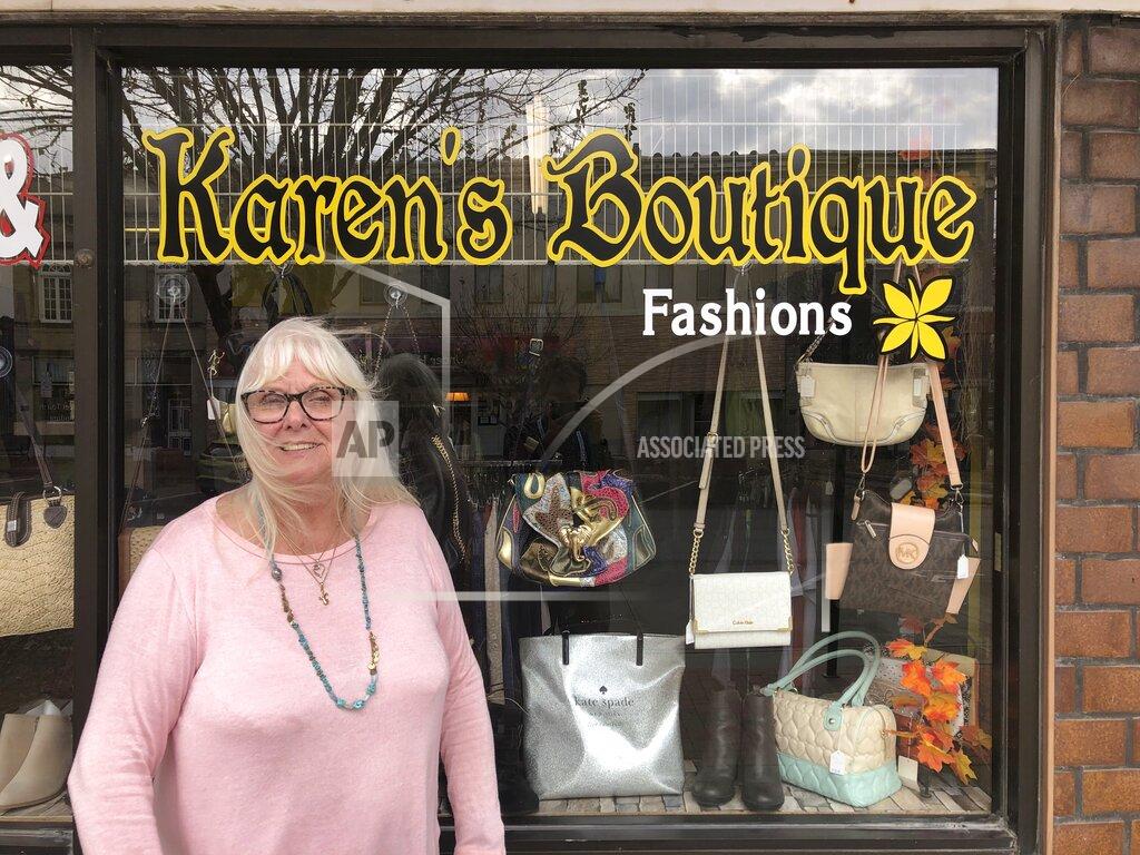 Karen Prohaska, 76, stands outside her purse and jewelry shop in downtown Plattsmouth, Nebraska, on Monday, Nov. 9, 2020. Prohaska says she hopes not to get the virus, but she usually doesn't wear a mask in her store because it hinders her breathing. She believes some people are overreacting to the threat. (AP Photo/Grant Schulte)
