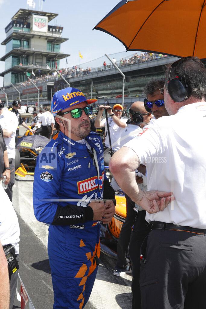 Michael Conroy FILE - In this May 18, 2019, file photo, Fernando Alonso, of Spain, talks with his crew as he prepares to qualify for the Indianapolis 500 IndyCar auto race at Indianapolis Motor Speedway in Indianapolis. Alonso will once again attempt to complete motorsports' version of the Triple Crown with a return to the Indianapolis 500 in May with McLaren. (AP Photo/Michael Conroy, File)