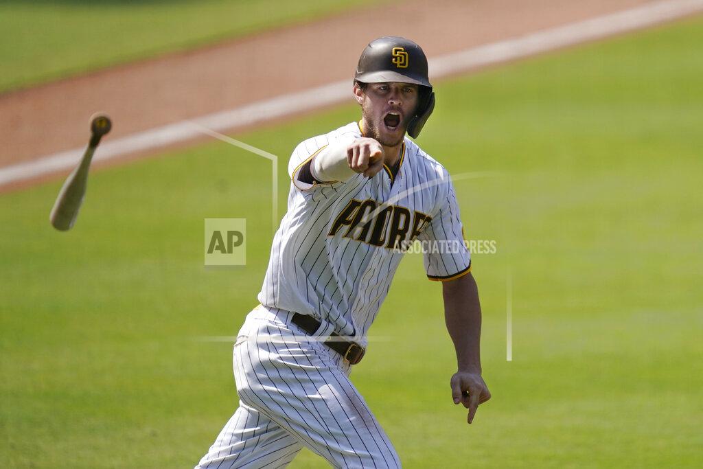 Gregory Bull FILE - In this Aug. 27, 2020 file photo, the San Diego Padres' Wil Myers reacts after hitting a three-run walkoff home run to defeat the Seattle Mariners in a baseball game in San Diego. Wil Myers is back. While Manny Machado and Fernando Tatis Jr. have grabbed most of the attention on the playoff-bound Padres, Myers' comeback performance has also been instrumental in returning San Diego to postseason play for the first time since 2006. Myers is hitting .291 with 14 homers and 38 RBIs in 52 games. (AP Photo/Gregory Bull, File)