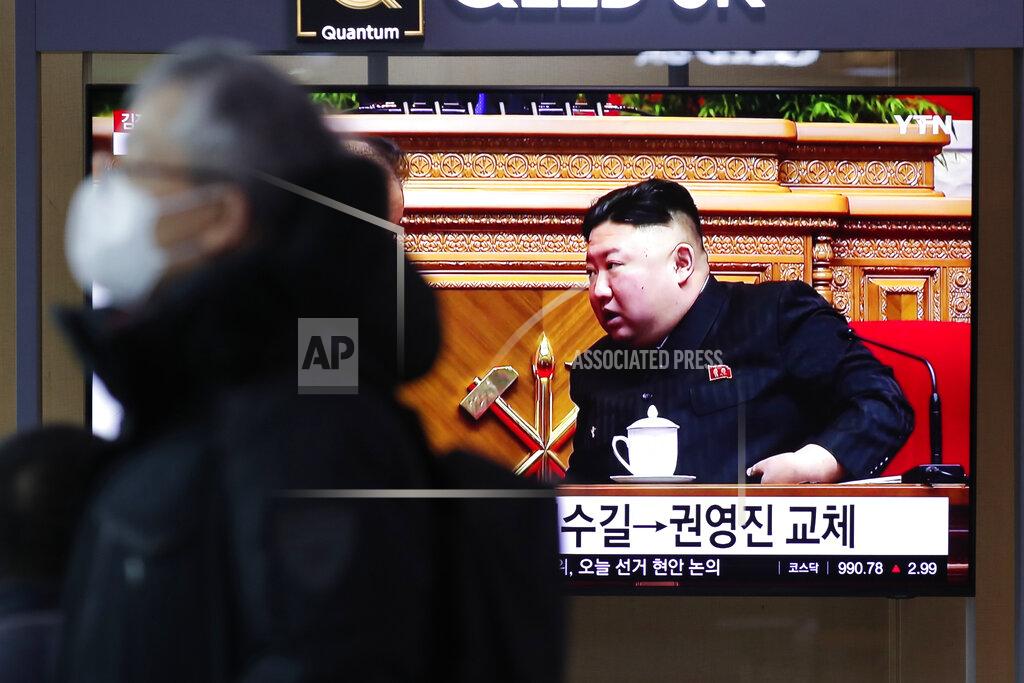 A man wearing a face mask walks past near a TV screen showing a footage of North Korean leader Kim Jong Un, at the Seoul Railway Station in Seoul, South Korea, Monday, Jan. 11, 2021. Kim was given a new title, “general secretary” of the ruling Workers’ Party, formerly held by his late father and grandfather, state media reported Monday, in what appears to a symbolic move aimed at bolstering his authority amid growing economic challenges. (AP Photo/Lee Jin-man)