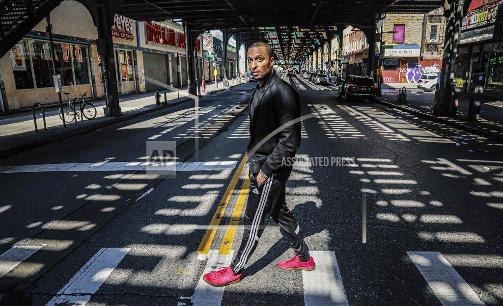 Bebeto Matthews In this March 26, 2020, photo, Rahmell Peeples walks in his neighborhood during an interview in the Brooklyn borough of New York. Peebles, who is skeptical of what he hears from white-run media and government, didn’t see the need for alarm over the new coronavirus. Peebles is one of roughly 40 million black Americans deciding minute by minute whether to put their faith in the government and medicine during the coronavirus pandemic. “I’ve just been conditioned not to trust,” Peebles said. (AP Photo/Bebeto Matthews)