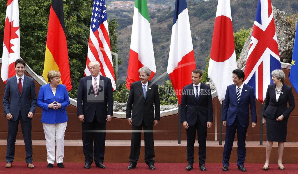 Andrew Medichini FILE - In this Friday, May 26, 2017 file photo, leaders of the G7, from left, Canadian Prime Minister Justin Trudeau, German Chancellor Angela Merkel, U.S. President Donald Trump, Italian Prime Minister Paolo Gentiloni, French President Emmanuel Macron, Japan's Prime Minister Shinzo Abe, and British Prime Minister Theresa May pose during a group photo for the G7 summit in the Ancient Theatre of Taormina in the Sicilian citadel of Taormina, Italy. Millions of women admire the 67-year-old for breaking through the glass ceiling of male dominance in politics, and she’s been lauded as an impressive role model for girls both at home and around the globe. (AP Photo/Andrew Medichini, File)