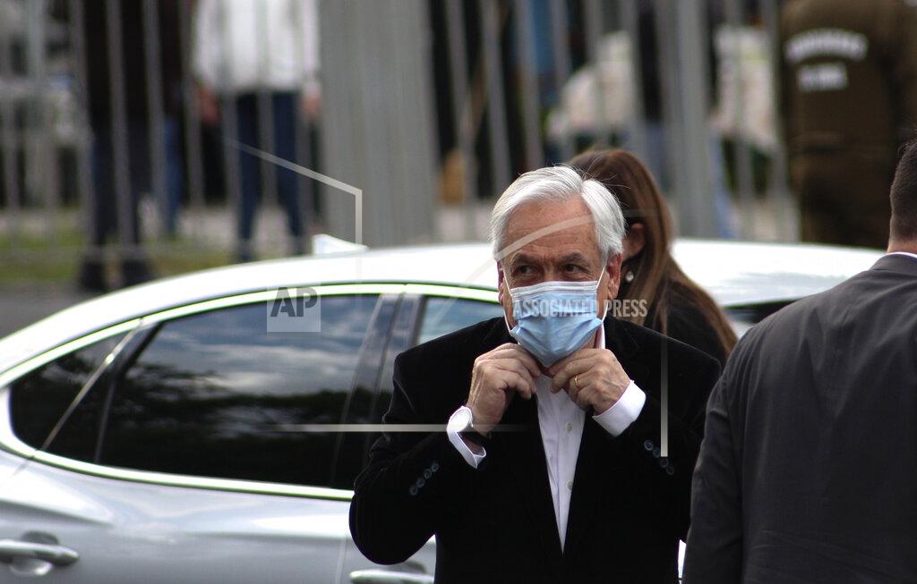 Esteban Felix Chilean President Sebastian Pinera arrives at a polling station to vote in Santiago, Chile, Sunday, Oct. 25, 2020. Amid a year of contagion and turmoil, Chileans vote Sunday on whether to draft a new constitution for their nation to replace guiding principles imposed four decades ago under a military dictatorship.(AP Photo/Esteban Felix)