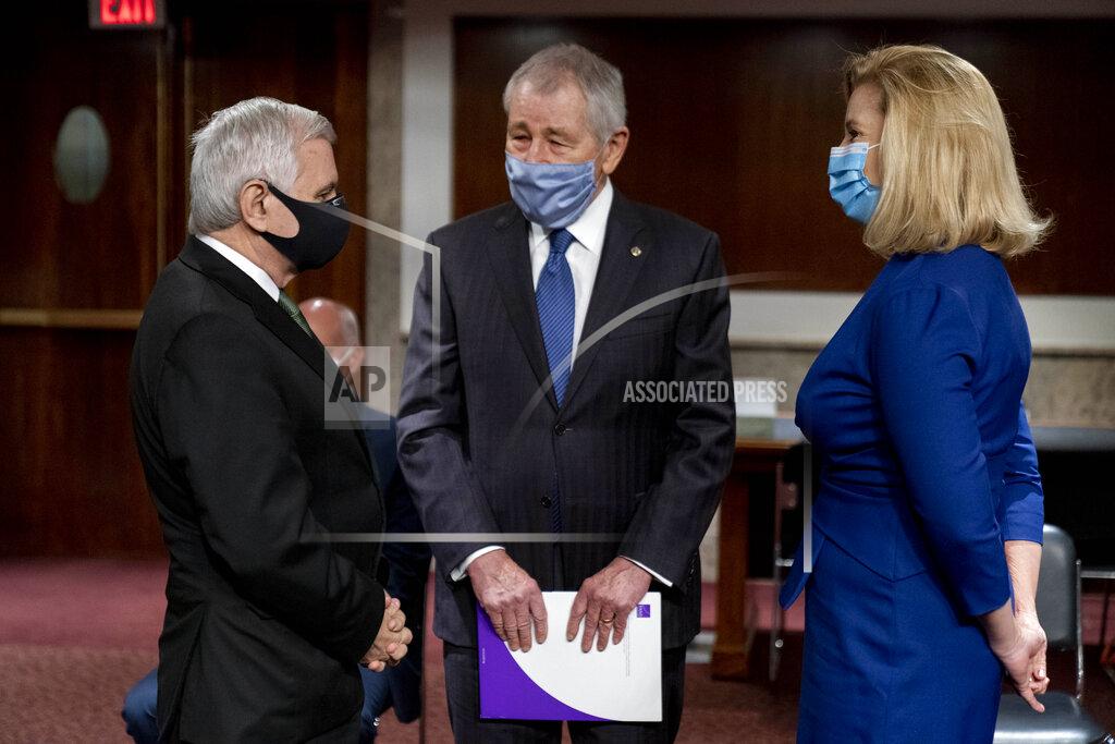 Andrew Harnik Nominee to be Secretary of the Army Christine Elizabeth Wormuth, right, speaks with Chairman Sen. Jack Reed, D-R.I., left, and former Secretary of Defense Chuck Hagel, center, before a Senate Armed Services Committee nomination hearing on Capitol Hill in Washington, Thursday, May 13, 2021. (AP Photo/Andrew Harnik)