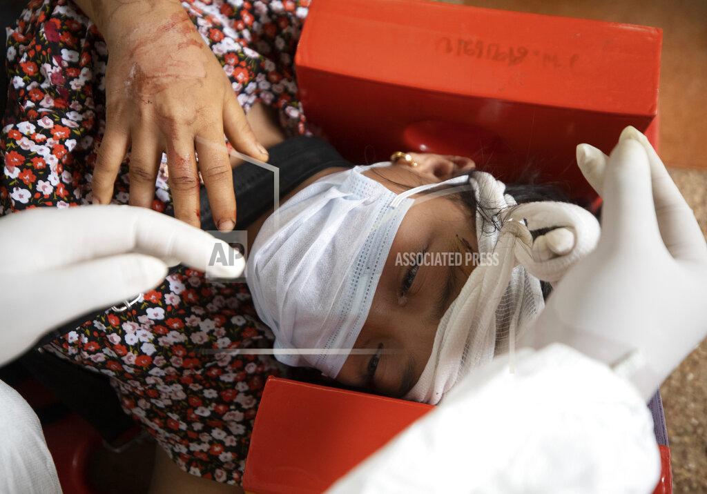 Sakchai Lalit An ethnic Karen villager from Myanmar is attended by a medical worker after crossing the Salawin river via boat at Ban Mae Sam Laep Health Center, Mae Hong Son province, Thailand, Tuesday, March 30, 2021. The weekend strikes by the Myanmar military, which sent ethnic people to seek safety in Thailand, represented another escalation in the violent crackdown by Myanmar’s junta on protests of its Feb. 1 takeover. (AP Photo/Sakchai Lalit)