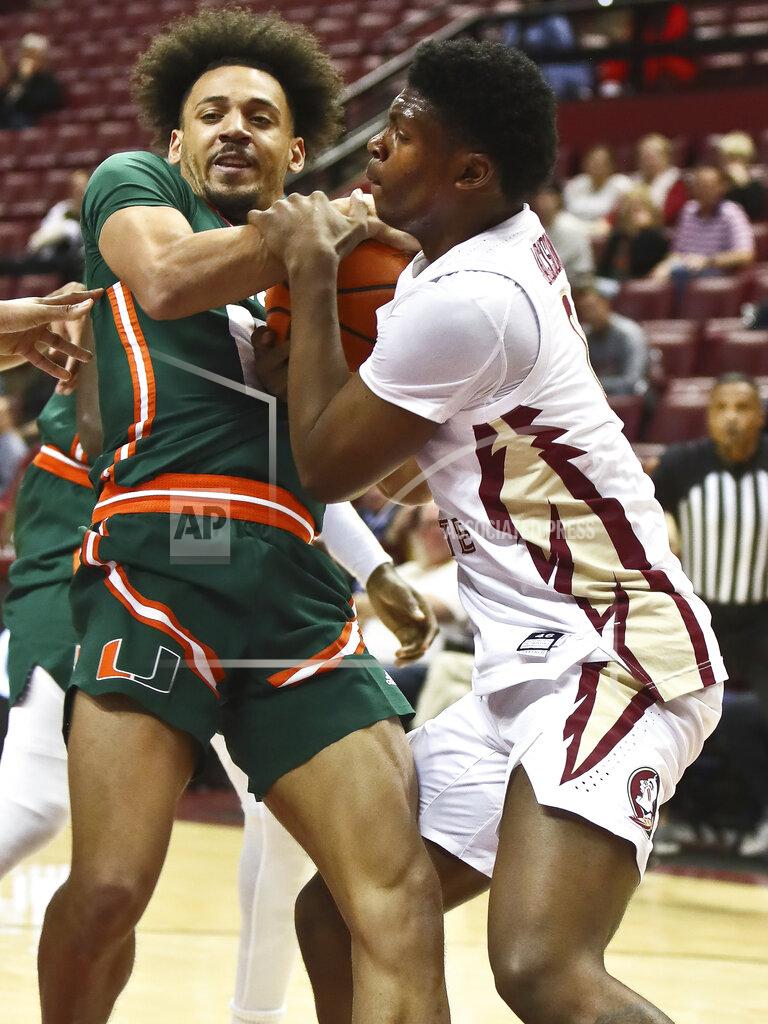Phil Sears Miami guard Jakai Robinson (13) gets into a jump ball call with Florida State guard Chandler Jackson (0) in the second half of an NCAA college basketball game in Tallahassee, Fla., Tuesday, Jan. 24, 2023. (AP Photo/Phil Sears)