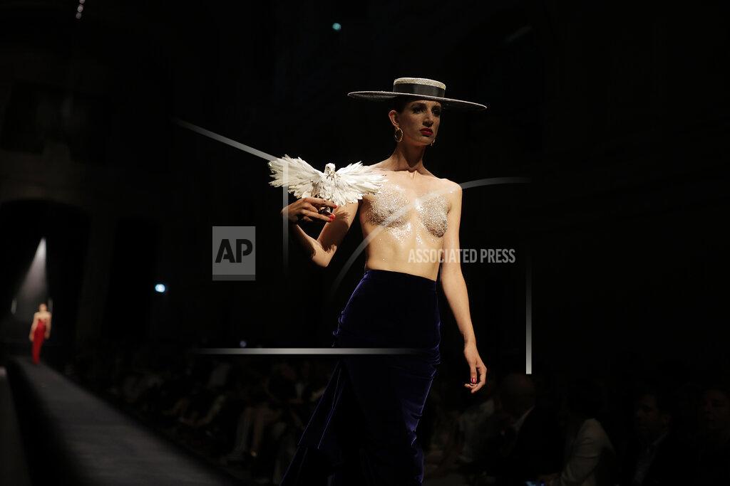 Lewis Joly EDS NOTE: NUDITY - A model wears a creation for Schiaparelli's Haute Couture Fall/Winter 2022-2023 fashion collection, Monday, July 4, 2022 in Paris. (AP Photo/Lewis Joly)