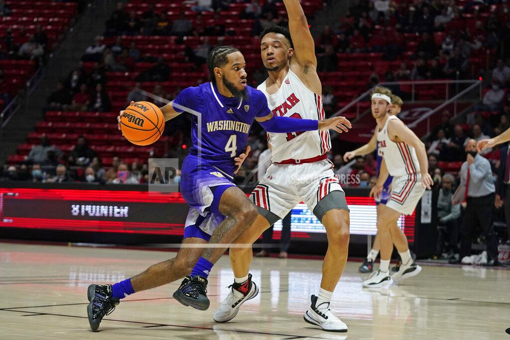 Rick Bowmer Washington guard PJ Fuller (4) drives as Utah guard Marco Anthony defends during the first half of an NCAA college basketball game Thursday, Jan. 6, 2022, in Salt Lake City. (AP Photo/Rick Bowmer)