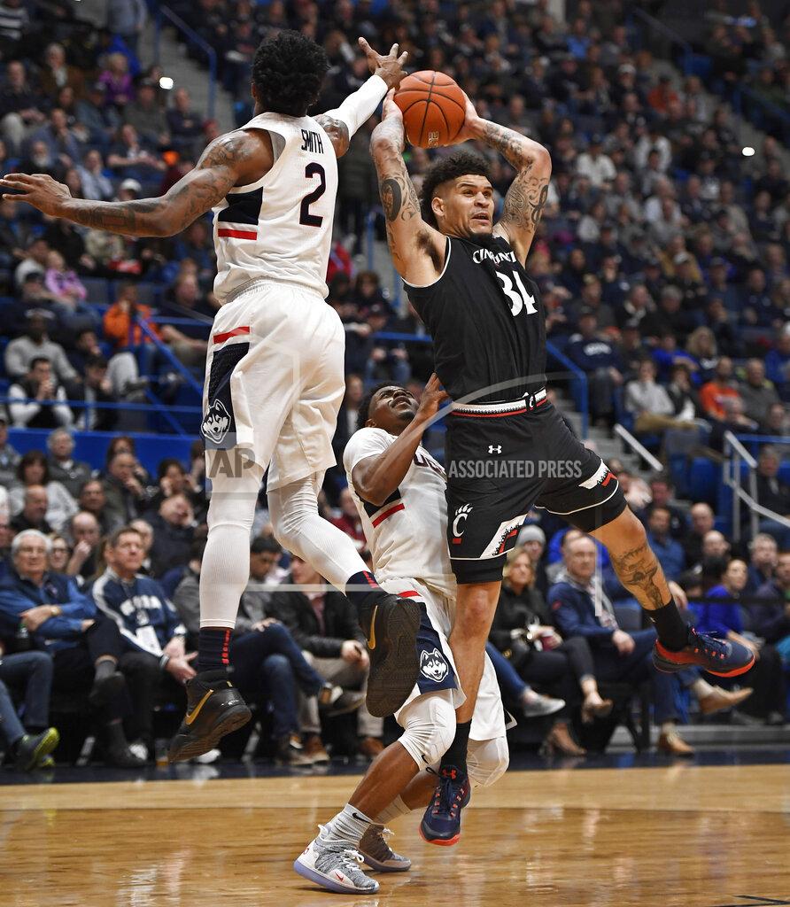 Jessica Hill Cincinnati's Jarron Cumberland (34) passes under pressure from Connecticut's Tarin Smith (2) and Alterique Gilbert (3) during the second half of an NCAA college basketball game, Sunday, Feb. 24, 2019, in Hartford, Conn. (AP Photo/Jessica Hill)