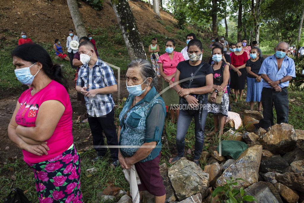 Rodrigo Abd La Reina residents left homeless when their community was buried in an epic mudslide triggered by Hurricanes Eta and Iota, attend an outdoor Mass at Mission San Francisco de Asis, Honduras, Sunday, June 27, 2021. It was the the first time in recorded history that successive Category 4 and 5 Atlantic hurricanes slammed the same place. (AP Photo/Rodrigo Abd)