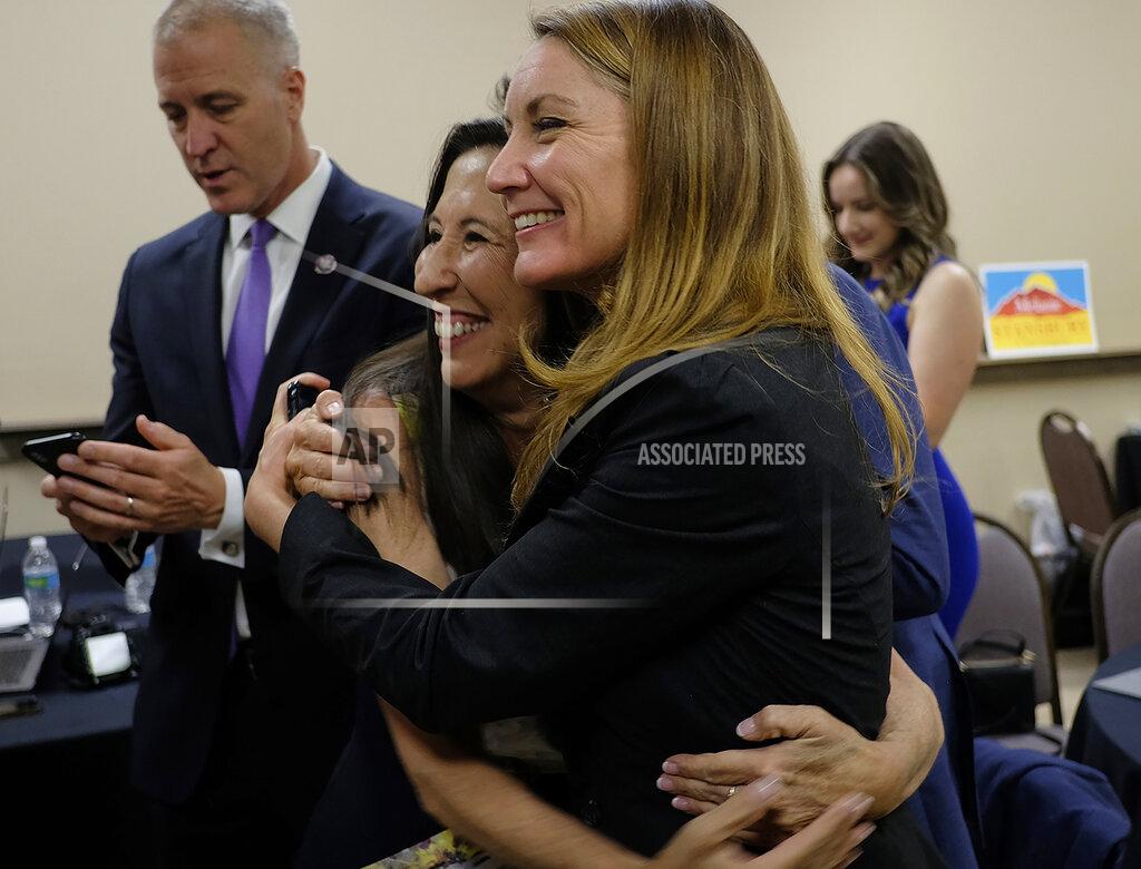Adolphe Pierre-Louis U.S. Rep. Teresa Leger Fernandez, center left, hugs Melanie Stansbury, as U.S. Rep. Sean Patrick Maloney, left, checks his phone at the Hotel Albuquerque, Tuesday, June 1, 2021, in Albuquerque, N.M., as results come in for the New Mexico 1st Congressional District special election to fill former U.S. Rep. Deb Haaland's seat. Haaland resigned her seat to become United States Secretary of the Interior. (Adolphe Pierre-Louis/The Albuquerque Journal via AP)