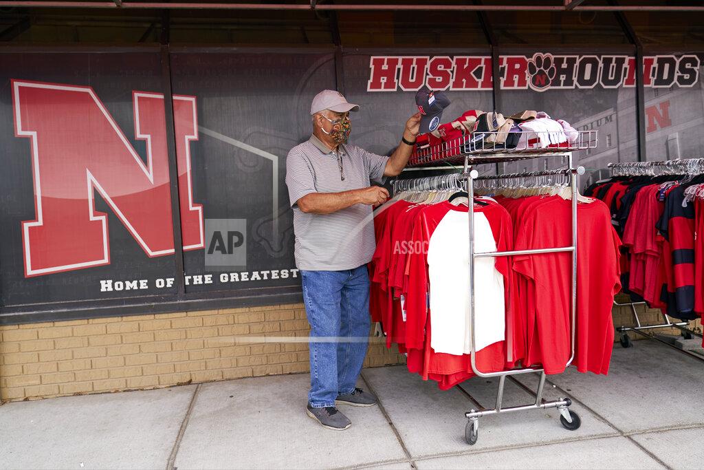 Nati Harnik Steve Skradska shops for discounted Nebraska merchandise at the Husker Hounds store in Omaha, Neb., Wednesday, Aug. 12, 2020. The Big Ten conference announced on Tuesday, Aug. 11, 2020, they won't play football this fall because of concerns about COVID-19, becoming the first of college sports' power conferences to yield to the pandemic. (AP Photo/Nati Harnik)