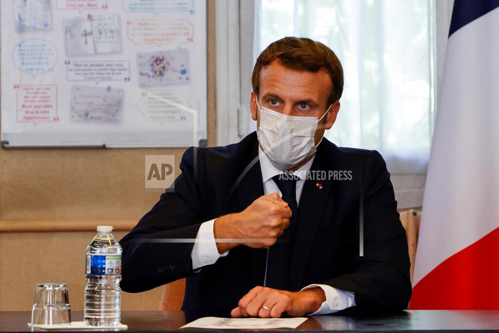 Ludovic Marin French President Emmanuel Macron chairs a meeting with the medical staff of the Rene Dubos hospital center, in Pontoise, outside Paris, Friday Oct. 23, 2020. French Prime Minister Jean Castex said Thursday a vast extension of the nightly curfew that is intended to curb the spiraling spread of the coronavirus, saying "the second wave is here." The curfew imposed in eight regions of France last week, including Paris and its suburbs, is being extended to 38 more regions and Polynesia, (Photo by Ludovic Marin, Pool via AP)