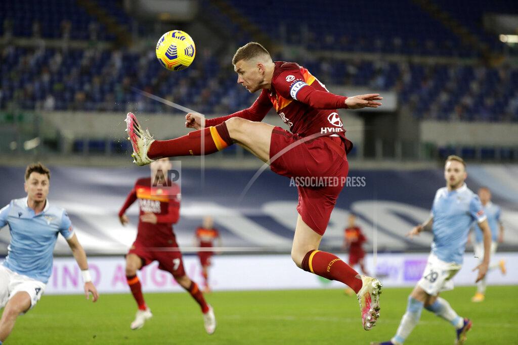 Andrew Medichini Roma's Edin Dzeko aims for the ball during the Serie A soccer match between Lazio and Roma, at Rome's Olympic Stadium, Friday, Jan. 15, 2021. (AP Photo/Andrew Medichini)