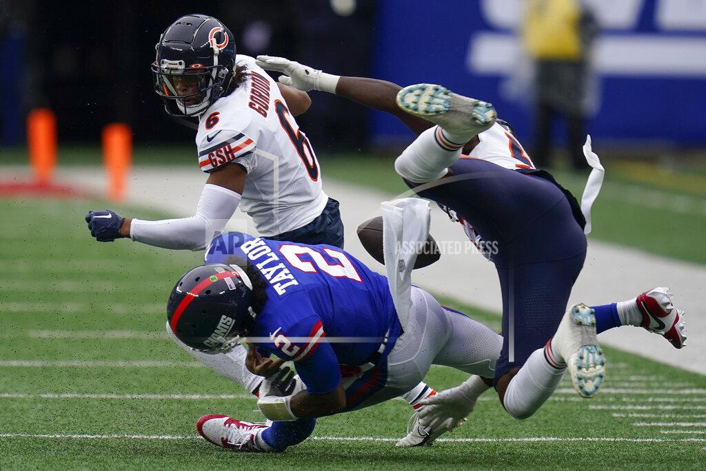 Seth Wenig New York Giants quarterback Tyrod Taylor (2) fumbles the ball as he is hit by Chicago Bears cornerback Kyler Gordon (6) and linebacker Nicholas Morrow (53) during the fourth quarter of an NFL football game, Sunday, Oct. 2, 2022, in East Rutherford, N.J. (AP Photo/Seth Wenig)