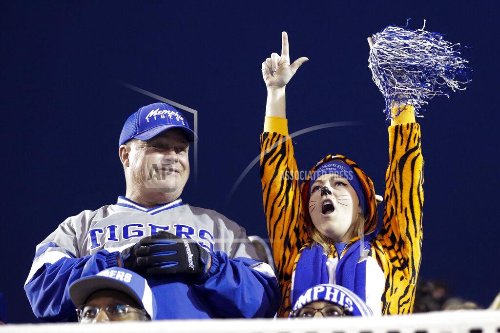 Mark Humphrey A Memphis fan, right, cheers in the second half of an NCAA college football game against Cincinnati, Friday, Nov. 29, 2019, in Memphis, Tenn. (AP Photo/Mark Humphrey)