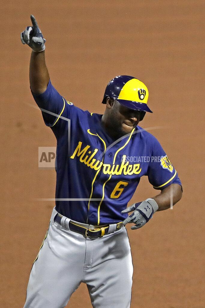 Gene J. Puskar Milwaukee Brewers' Lorenzo Cain celebrates at first base after driving in a run with a single off Pittsburgh Pirates relief pitcher Nik Turley during the seventh inning of a baseball game in Pittsburgh, Monday, July 27, 2020. (AP Photo/Gene J. Puskar)