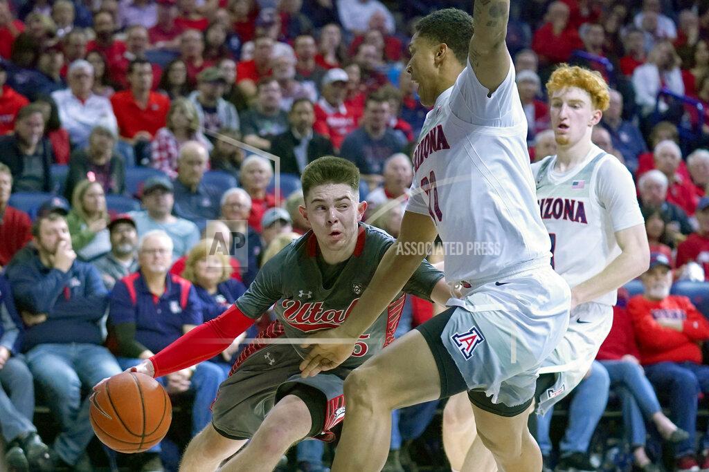 Rick Scuteri Utah guard Rylan Jones (15) drives against Arizona guard Nico Mannion and Ira Lee (11) during the first half of an NCAA college basketball game Thursday, Jan. 16, 2020, in Tucson, Ariz. (AP Photo/Rick Scuteri)