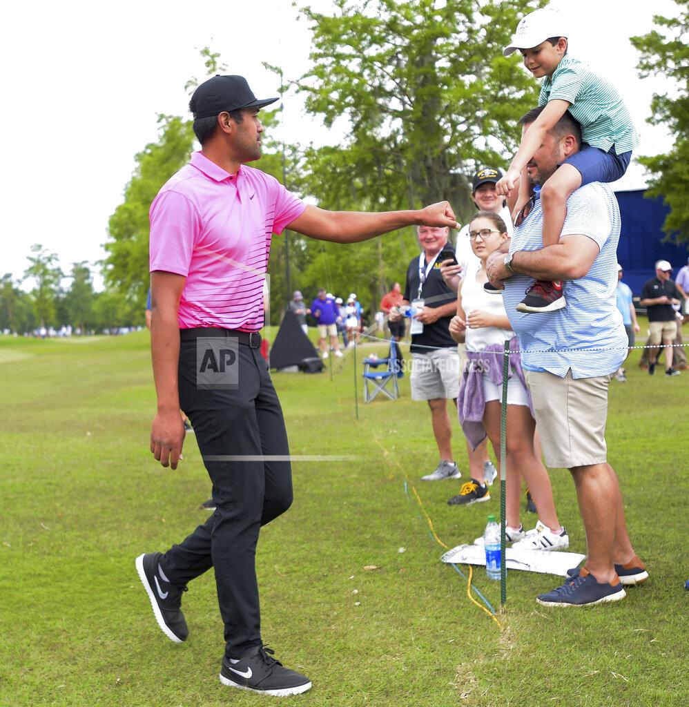 Max Becherer Tony Finau bumps fists with a young fan during the second round of the Zurich Classic golf tournament at TPC Louisiana in Avondale, La., Friday, April 23, 2021. (Max Becherer/The Times-Picayune/The New Orleans Advocate via AP)