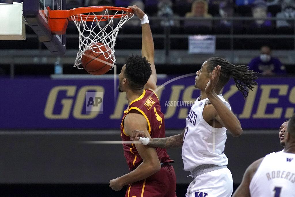 Ted S. Warren Southern California forward Isaiah Mobley dunks next to Washington forward Hameir Wright during the first half of an NCAA college basketball game Thursday, Feb. 11, 2021, in Seattle. (AP Photo/Ted S. Warren)