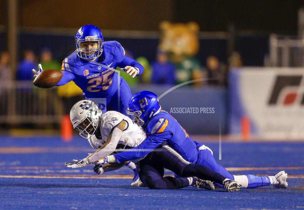 Steve Conner Boise State linebacker Benton Wickersham (25) dives for the ball after Boise State safety Tyreque Jones (21) broke up a pass to Utah State wide receiver Jordan Nathan (16) during the first half of an NCAA college football game, Saturday, Nov. 24, 2018, in Boise, Idaho. (AP Photo/Steve Conner)