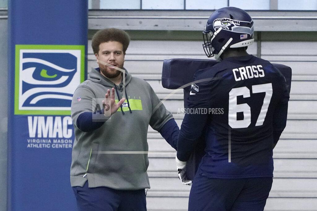 Ted S. Warren Seattle Seahawks offensive tackle Charles Cross (67) works with offensive line coach Andy Dickerson, left, during NFL football rookie minicamp Friday, May 6, 2022, in Renton, Wash. (AP Photo/Ted S. Warren)