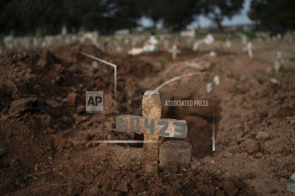 Leo Correa A cross marks the grave of 57-year-old Paulo Jose da Silva, who died from the new coronavirus, in Rio de Janeiro, Brazil, Friday, June 5, 2020. According to Monique dos Santos, her stepfather mocked the existence of the virus, didn't use a mask, didn't take care of himself, and wanted to shake hands with everybody. "He didn't believe in it and unfortunately he met this end. It's very sad, but that's the truth," she said. (AP Photo/Leo Correa)